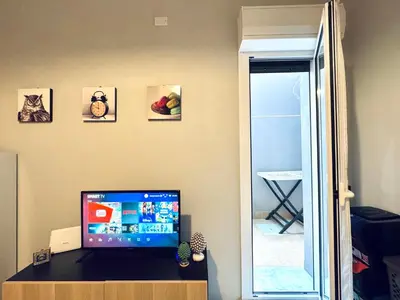 a computer monitor sitting on a desk in a room at Angelia in Capaci