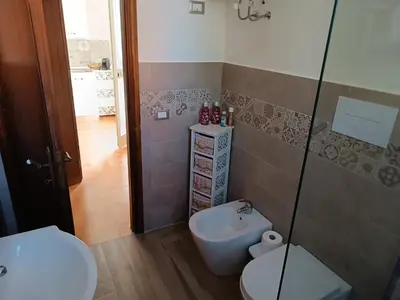 a bathroom with a toilet and a shower at Le Tremar Carini Poseidon in Carini