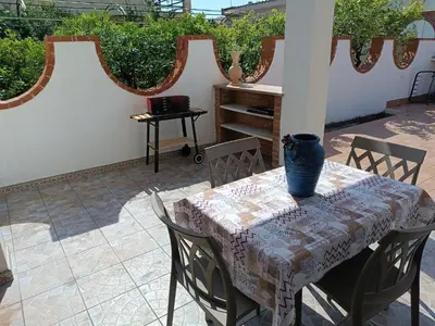 a table with a vase on it on a patio at Le Tremar Carini Poseidon in Carini