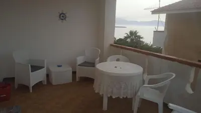 a white table and chairs in a room with a window at Sizilien 2 in Trappeto