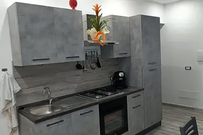 a kitchen with a sink and a stove top oven at Il Tramonto - BALESTRATE in Balestrate