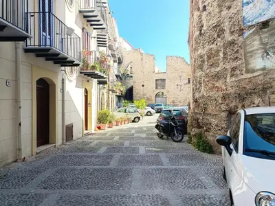 a street in the city with cars parked at appartamento centro storico - La casuzza alla Cala in Palermo