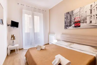 a bedroom with two beds and a red bus on the wall at Stabile 38 Apartments in Palermo