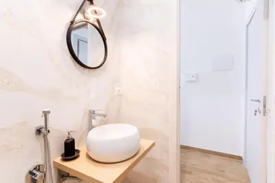 a bathroom with a white sink and a mirror at Stabile 38 Apartments in Palermo