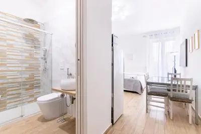 a bathroom with a shower and a sink and a toilet at Stabile 38 Apartments in Palermo