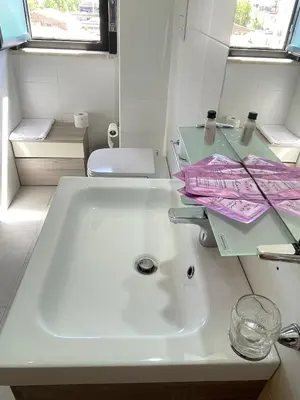 a bathroom with a sink and a toilet and a mirror at Casa vacanza ''I Mori di Carmen'' - Appartamento Eterno Amore in Palermo