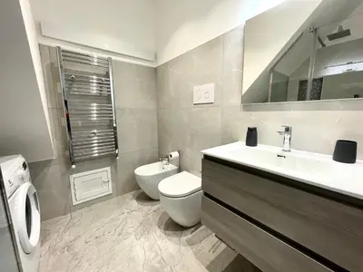 a bathroom with a toilet and a sink and mirror at Nel Cuore di Palermo Isidoro Palace in Palermo