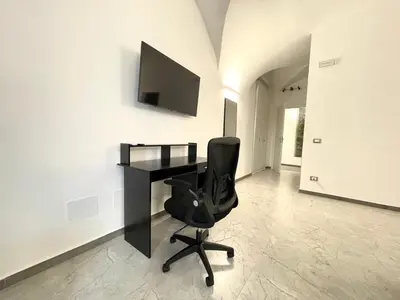 a black desk and a chair in a room at Nel Cuore di Palermo Isidoro Palace in Palermo