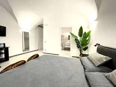 a bedroom with a large bed and a couch at Nel Cuore di Palermo Isidoro Palace in Palermo