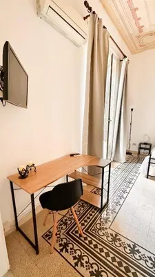 a desk with a chair and a television in a room at Da Cosimo U pitturi in Palermo