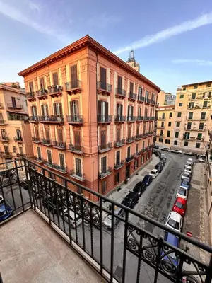 a view of a building with cars parked on a street at Da Cosimo U pitturi in Palermo