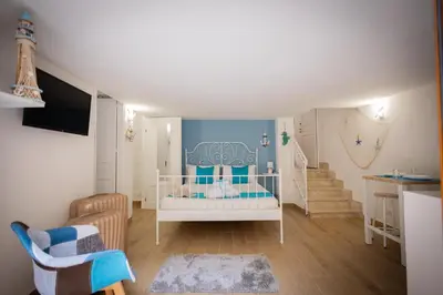 a childs room with a crib and a staircase at Scalini holiday in Castellammare del Golfo