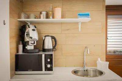 a kitchen with a sink and a microwave at Scalini holiday in Castellammare del Golfo