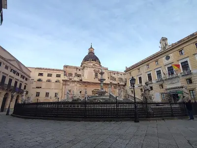a large building with a fence in front of it at Politeama my Suite in Palermo
