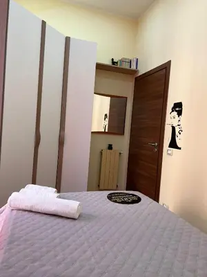 a bedroom with a bed with a towel on it at Ninohouse in Palermo