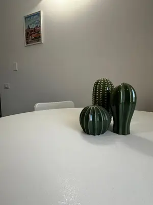 three green cactuses sitting on a white table at Il falchetto in Palermo