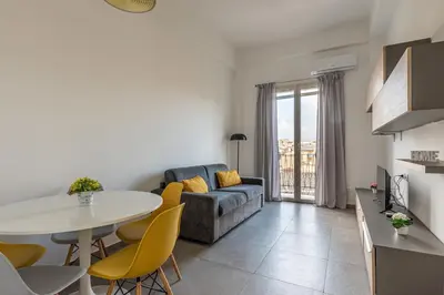 a living room with a couch and a table at Lumar Sicilia - Magione in Palermo