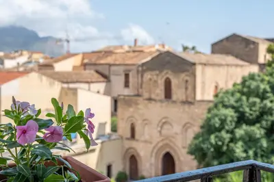 a vase with purple flowers sitting on a balcony at Lumar Sicilia - Magione in Palermo