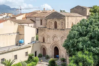 an old church in a city with buildings at Lumar Sicilia - Magione in Palermo