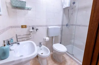 a bathroom with a toilet and a sink and a shower at Lumar Sicilia - Cattedrale in Palermo