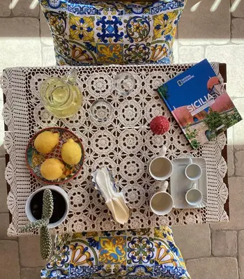 a table with a table cloth with food on it at Casa iusu - Home with patio near the sea and Palermo in Casteldaccia