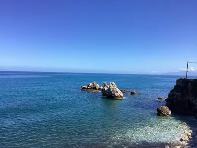 a group of rocks in the middle of the ocean at Casa iusu - Home with patio near the sea and Palermo in Casteldaccia