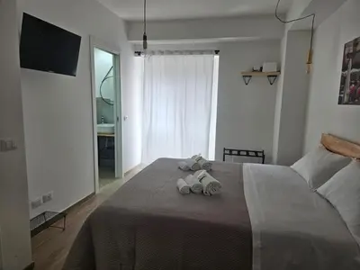 a bedroom with a bed with two towels on it at Porta D ossuna comfort apartments in Palermo