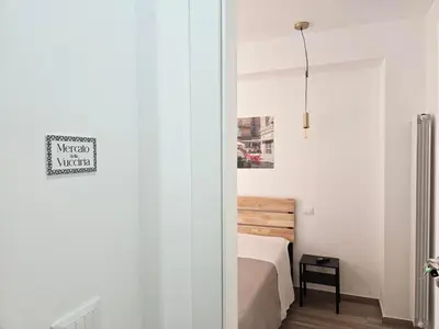 a bedroom with a bed and a sign on the wall at Porta D ossuna comfort apartments in Palermo