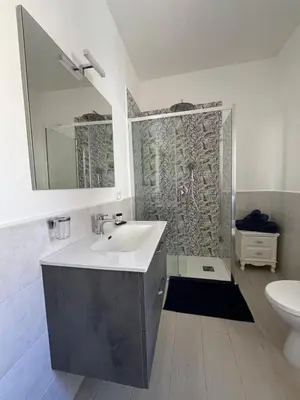 a bathroom with a sink and a shower at Nela Appartament in Bagheria
