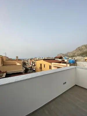 a balcony with a view of a city at Casa Nonna Lina in Isola delle Femmine