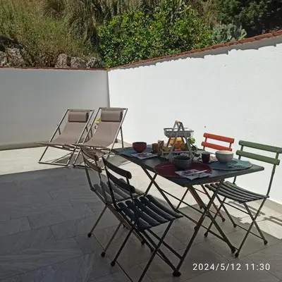 a table and chairs sitting on a patio at Mediterraneo Rooms in Castellammare del Golfo