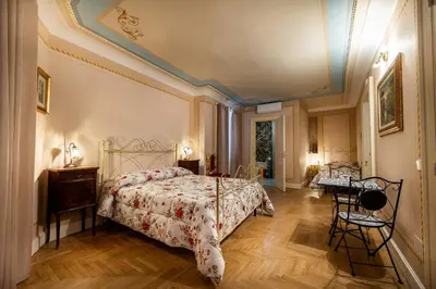 a bedroom with a bed and a table and chairs at Francy House in Termini Imerese
