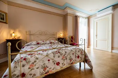 a bedroom with a bed with a floral bedspread at Francy House in Termini Imerese