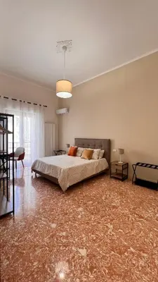 a large bedroom with a bed and a table at Kasa Stabile in Palermo