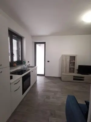 a kitchen with a sink and a stove at Casa Vacanze il Cortile in Casteldaccia