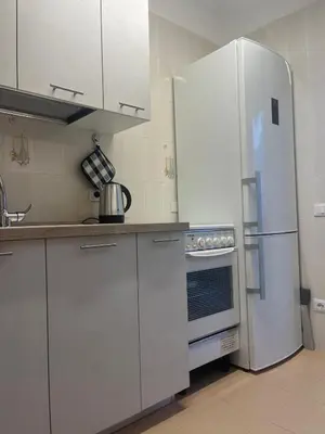 a kitchen with white cabinets and a refrigerator at Profumo di Mare 2 in Alcamo Marina