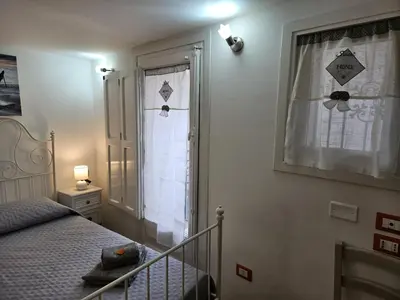 a bedroom with a bed and a window at Casa Pretoria in Palermo