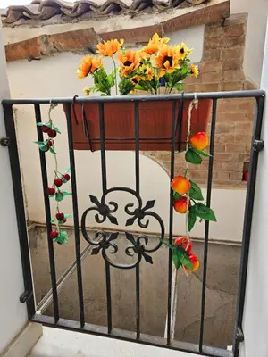 a vase filled with flowers on a balcony at Casa Pretoria in Palermo