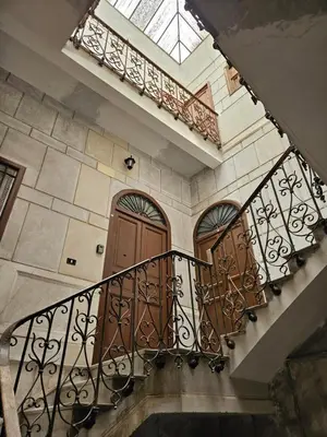 a staircase with two wooden doors and a window at Casa Pretoria in Palermo