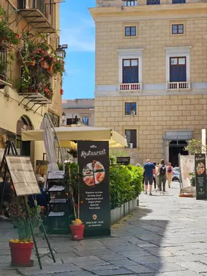 a sign on a sidewalk in front of a building at Casa Pretoria in Palermo