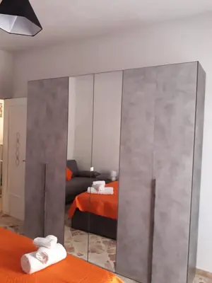a bedroom with a large mirror and a bed at La casa di Ross in Casteldaccia