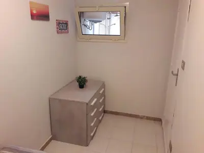 a small room with a dresser and a window at La casa di Ross in Casteldaccia