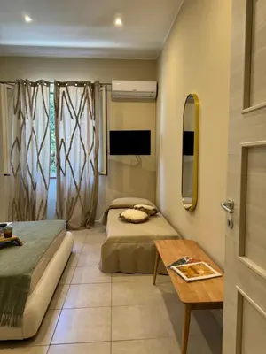 a bedroom with a bed and a mirror at Domus Fysi in Palermo