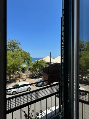 a view of a market with the ocean in the background at Domus Fysi in Palermo