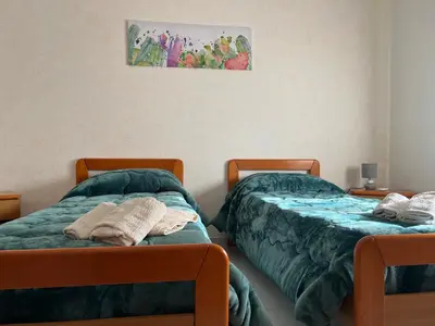 a bed with two towels on it in front of a window at Nonna Ciccina’s House in Vita