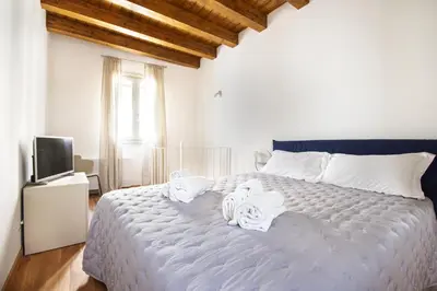 a bedroom with a large bed with towels on it at Cassari Maisons in Palermo
