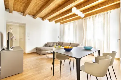 a living room with a table and chairs at Cassari Maisons in Palermo