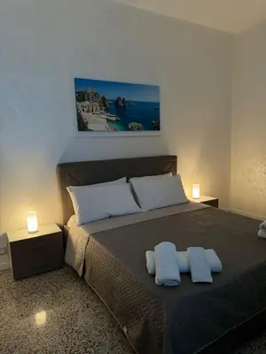 a bedroom with a bed with two towels on it at Karma House in Palermo