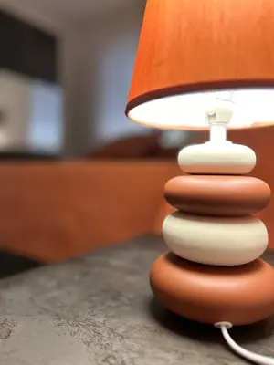 a close up of a lamp with a stack of rocks at Casa Iohana in San Vito lo Capo