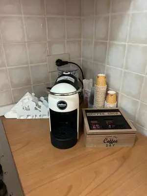 a coffee maker sitting on a counter next to a box at Casa Iohana in San Vito lo Capo